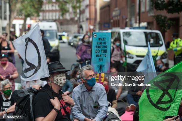 Extinction Rebellion activists protest against climate change and the plight of refugees outside the Home Office on September 4, 2020 in London,...