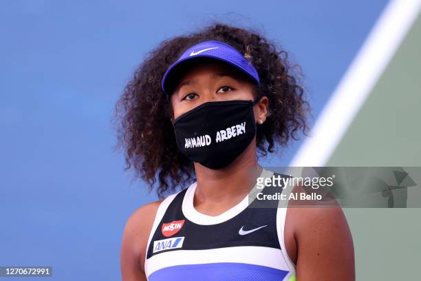 Naomi Osaka of Japan wears a protective face mask with the name, Ahmaud Arbery stenciled on it after winning her Women's Singles third round match...