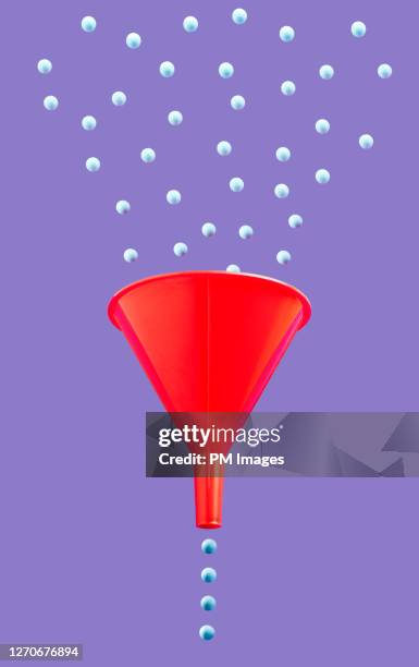 funneling little blue balls - tracking progress stock pictures, royalty-free photos & images