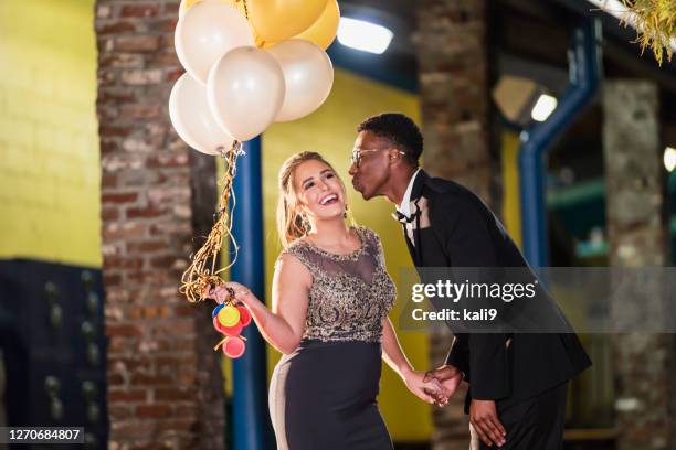 teenage couple after prom, kiss on cheek - cheek kiss stock pictures, royalty-free photos & images