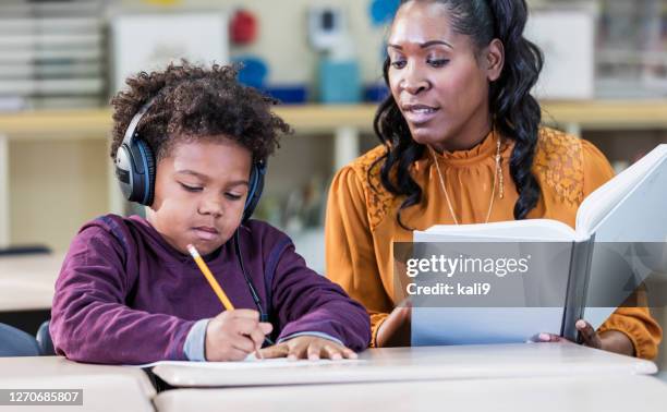 african-american teacher and elementary school student - special education stock pictures, royalty-free photos & images