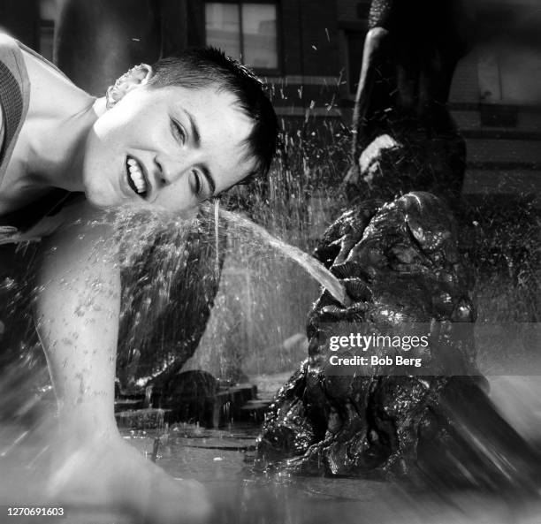 Lead singer Dolores O'Riordan of the Irish rock band The Cranberries poses for a portrait while playing in a water fountain circa June, 1995 in New...