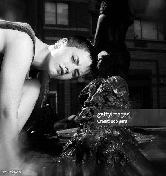 Lead singer Dolores O'Riordan of the Irish rock band The Cranberries poses for a portrait while playing in a water fountain circa June, 1995 in New...