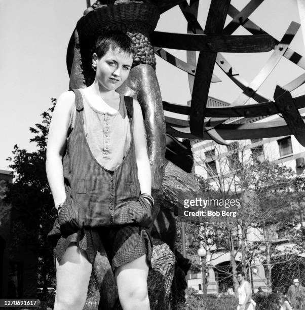 Lead singer Dolores O'Riordan of the Irish rock band The Cranberries poses for a portrait in front of a city sculpture circa June, 1995 in New York...