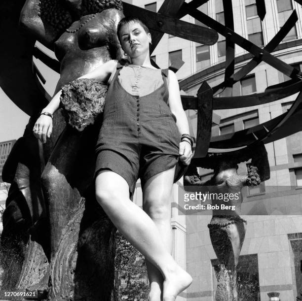 Lead singer Dolores O'Riordan of the Irish rock band The Cranberries poses for a portrait in front of a city sculpture circa June, 1995 in New York...
