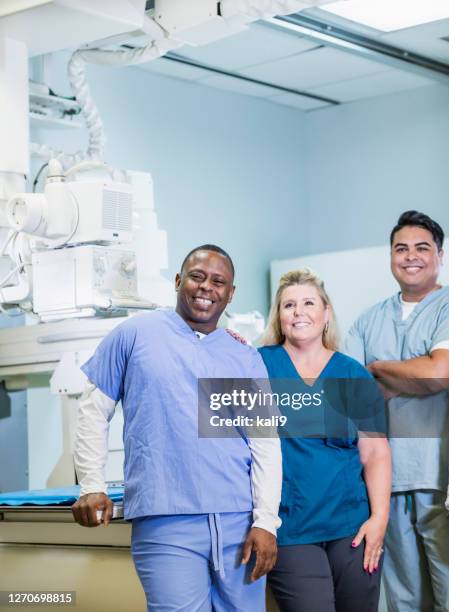 technologists with x-ray equipment - radiographer stock pictures, royalty-free photos & images