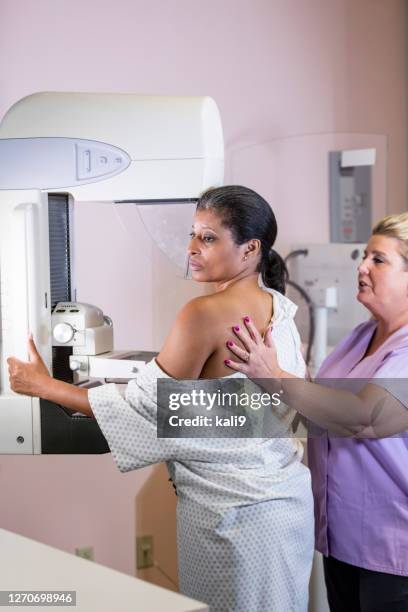 african-american woman getting a mammogram - mammogram diversity stock pictures, royalty-free photos & images