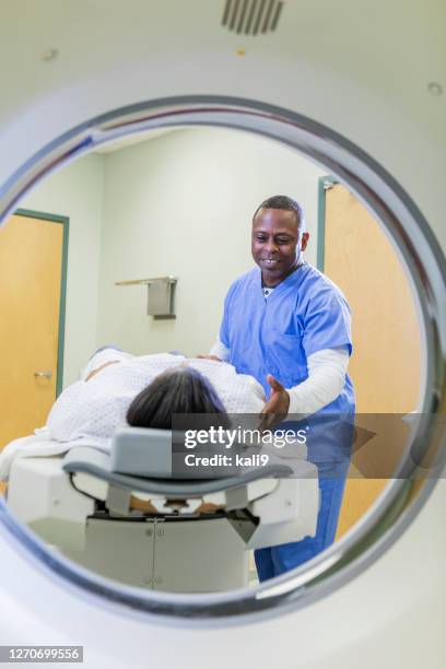 african-american woman getting a ct scan - x-ray technician stock pictures, royalty-free photos & images