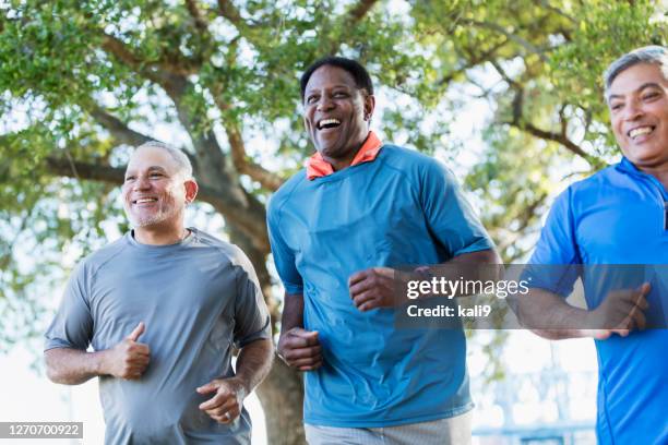 three multi-ethnic men jogging together - 3 old men jogging stock pictures, royalty-free photos & images