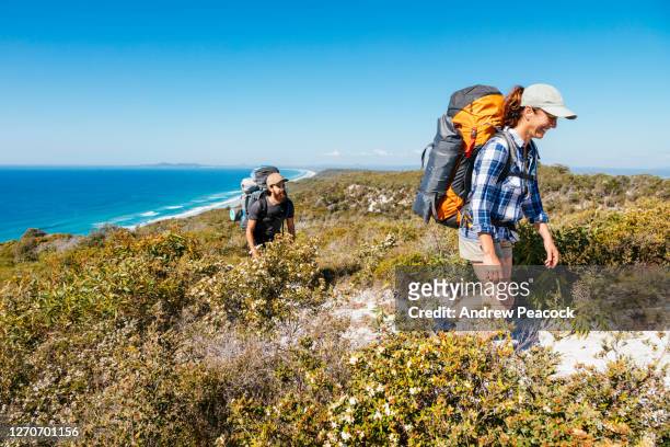 man and woman hiking in great sandy national park, noosa heads, queensland, australia - hiking australia stock pictures, royalty-free photos & images