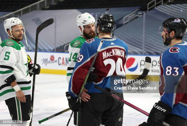 Nathan MacKinnon of the Colorado Avalanche and Jamie Benn of the Dallas Stars and their teammates shake hands after Game Seven of the Western...