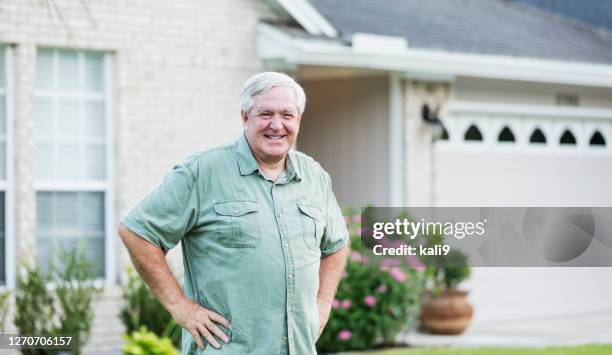 senior man standing in front of home - proud old man stock pictures, royalty-free photos & images