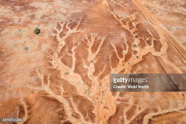 aerial viewpoint looking down on the dry river beds and cracked earth of outback australia - outback australia stock pictures, royalty-free photos & images