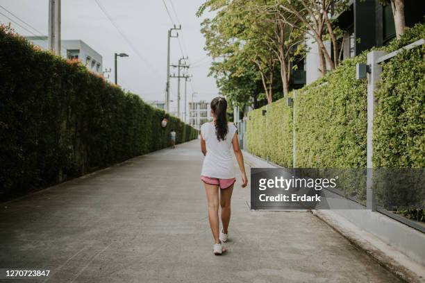 walking for warming up around her apartment in an early morning-stock photo - warming up for exercise stock pictures, royalty-free photos & images