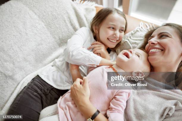 happy mother with daughter and baby girl relaxing at home - family with two children stock pictures, royalty-free photos & images
