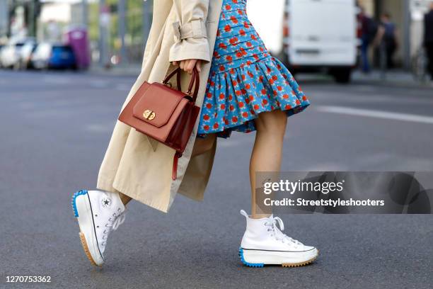 Influencer and model Frankie Miles wearing white sneaker with blue and beige sole details Run Star Hike JW Anderson by Converse, a midi length blue...