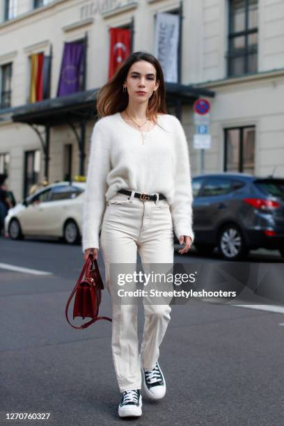 Influencer and model Frankie Miles wearing jewelry by Ariane Ernst, black and white elevation platform sneaker by Converse, a cream colored angora...