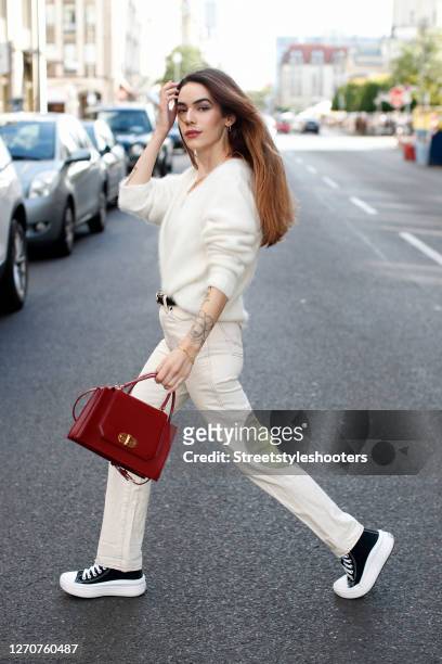 Influencer and model Frankie Miles wearing jewelry by Ariane Ernst, black and white elevation platform sneaker by Converse, a cream colored angora...