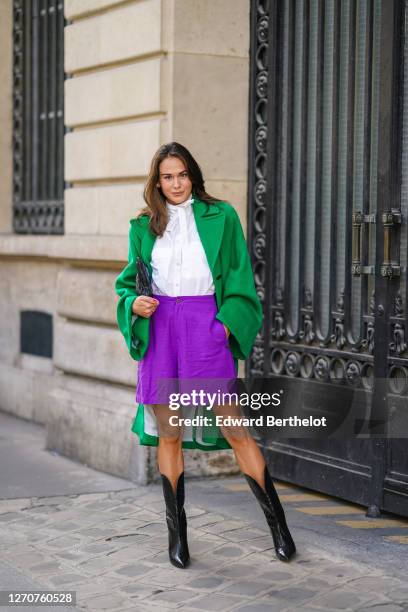 Therese Hellström wears black leather high heels pointy crocodile pattern boots from Custommade, purple shorts from Scotch & Soda, a white shirt /...