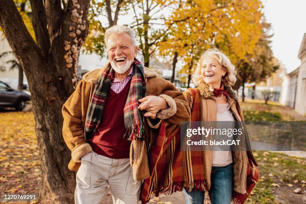 happy senior couple enjoying in autumn day - elder fall stock pictures, royalty-free photos & images