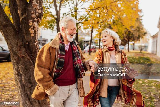 happy senior couple enjoying in autumn day - elder fall stock pictures, royalty-free photos & images
