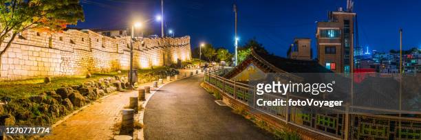 seoul city walls illuminated at night overlooking homes panorama korea - lotte world tower stock pictures, royalty-free photos & images