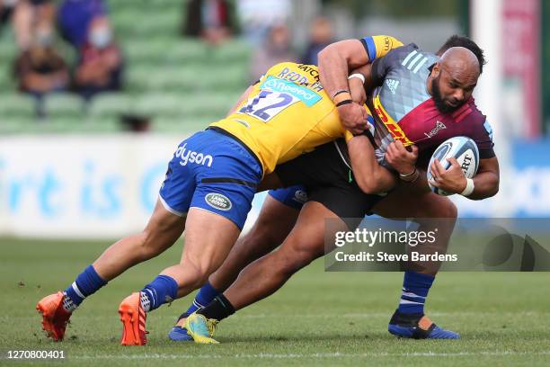 Paul Lasike of Harlequins is tackled by Cameron Redpath and Lewis Boyce of Bath Rugby during the Gallagher Premiership Rugby match between Harlequins...