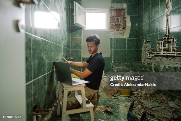 learning to fix water pipes - cluttered bathroom stock pictures, royalty-free photos & images
