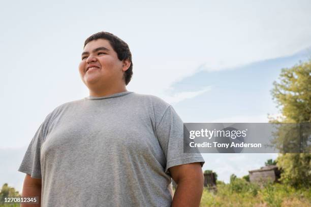 young man standing outdoors - handsome native american men stock pictures, royalty-free photos & images