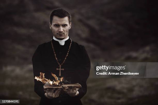 monk holding burning book - diablo dam stock pictures, royalty-free photos & images