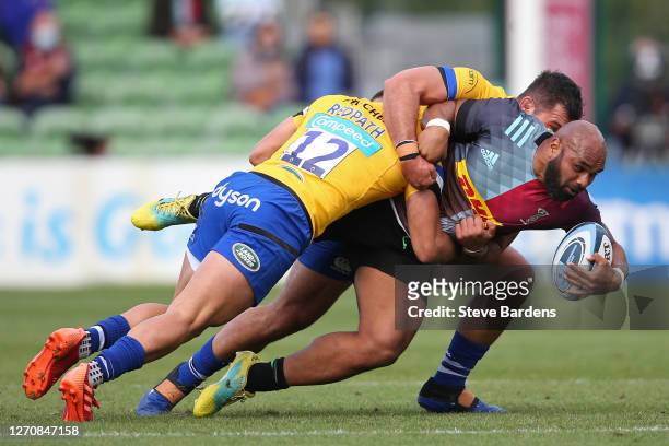 Paul Lasike of Harlequins is tackled by Cameron Redpath and Lewis Boyce of Bath Rugby during the Gallagher Premiership Rugby match between Harlequins...