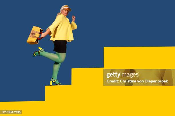 curvy fashionista in yellow and green colors - woman walks down street stock pictures, royalty-free photos & images