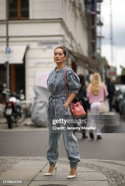 Anna Schürrle wearing Ulla Johnson blue jeans jumpsuits, Rosa Mansur Gavriel bag and beige Gianvito Rossi heels on September 04, 2020 in Berlin,...