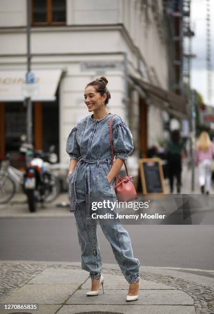 Anna Schürrle wearing Ulla Johnson blue jeans jumpsuits, Rosa Mansur Gavriel bag and beige Gianvito Rossi heels on September 04, 2020 in Berlin,...