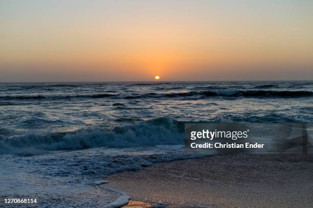 The sun sets over the sea in Swakopmund, Namibia, on April 3, 2019. Located on the coast of Namibia, Swakopmund is one of the most populous cities in...