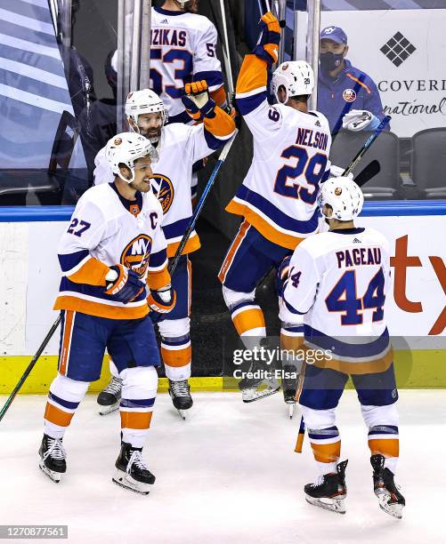 Andy Greene, Anders Lee, Brock Nelson and Jean-Gabriel Pageau of the New York Islanders of the New York Islanders celebrate their teams 4-0 victory...