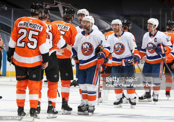 Andy Greene of the New York Islanders and Jakub Voracek of the Philadelphia Flyers and their teammates shake hands after Game Seven of the Eastern...
