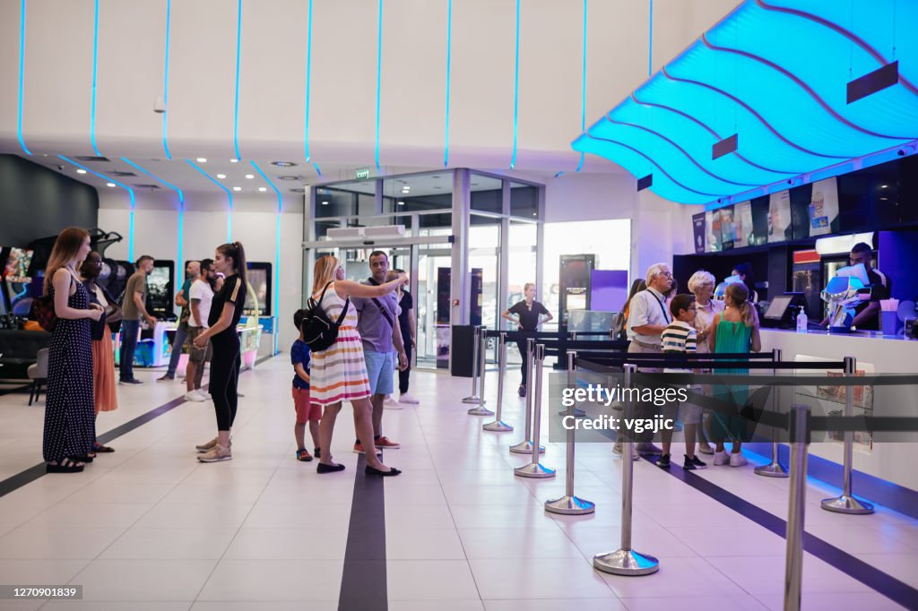 Reopening Cinema - People Buying Movie Tickets At Concession Stand In Cinema