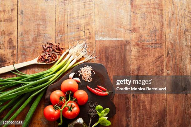 spring onions, red tomatoes,chillies and other spices on wooden table - full frame vegatable stock pictures, royalty-free photos & images