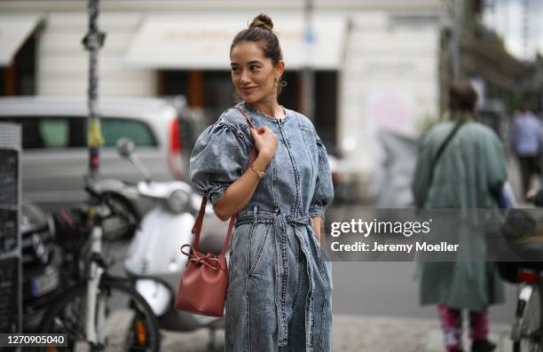 Anna Schürrle wearing Ulla Johnson blue jeans jumpsuits and rosa Mansur Gavriel bag on September 04, 2020 in Berlin, Germany.