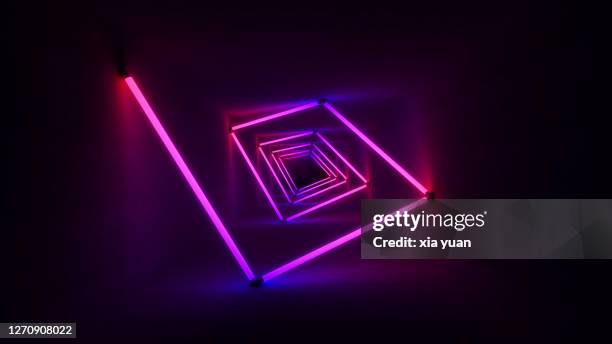 colourful neon lights illuminating tunnel - luce fluorescente foto e immagini stock