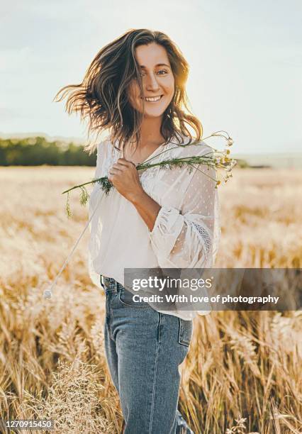 smiling mid adult woman beautiful enjoying natural beauty in rye field in the countryside outdoors, august in a villgage lifestyle - rye grain stock-fotos und bilder