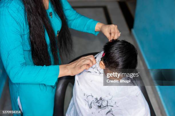 mother cutting child's hair at home. - boy with long hair stock pictures, royalty-free photos & images