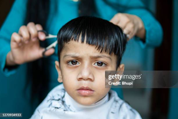 mother cutting child's hair at home. - boy indian stock pictures, royalty-free photos & images