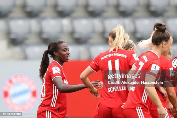 Viviane Asseyi of FC Bayern Muenchen celebrates scoring the opening goal with her team mates during the Flyeralarm Frauen Bundesliga match between FC...