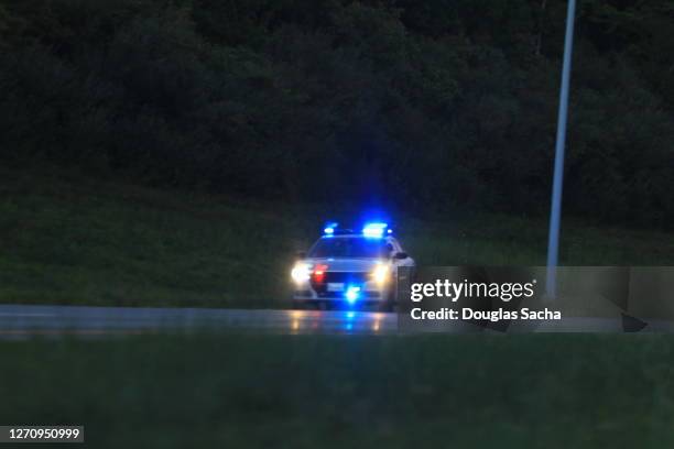 illuminated police car lights and sirens - police lights stock-fotos und bilder