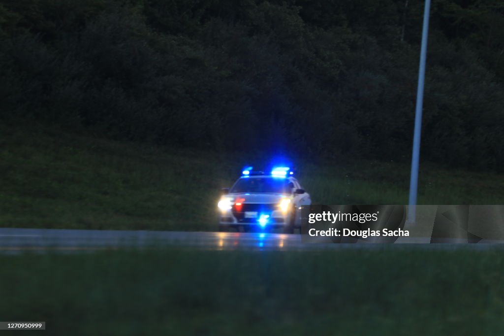 Illuminated police car lights and sirens