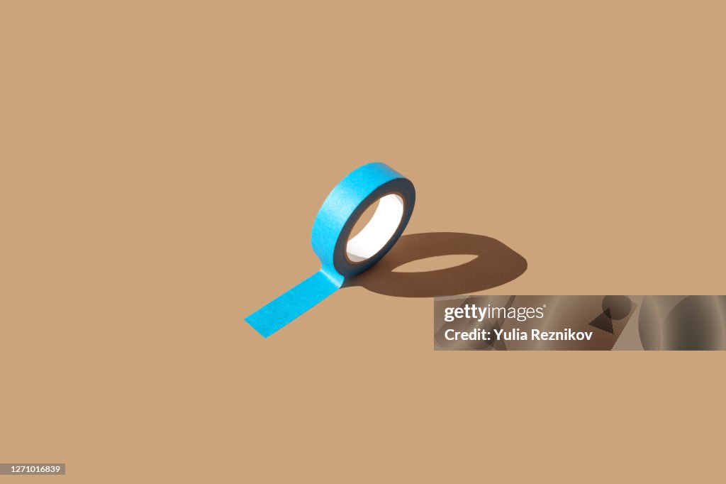 One blue masking tape on the beige background