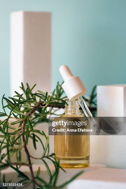 glass bottle with pipette in modern studio - rosemary fotografías e imágenes de stock