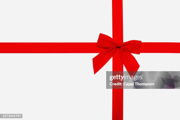 red christmas bow isolated over white background - bow photos et images de collection